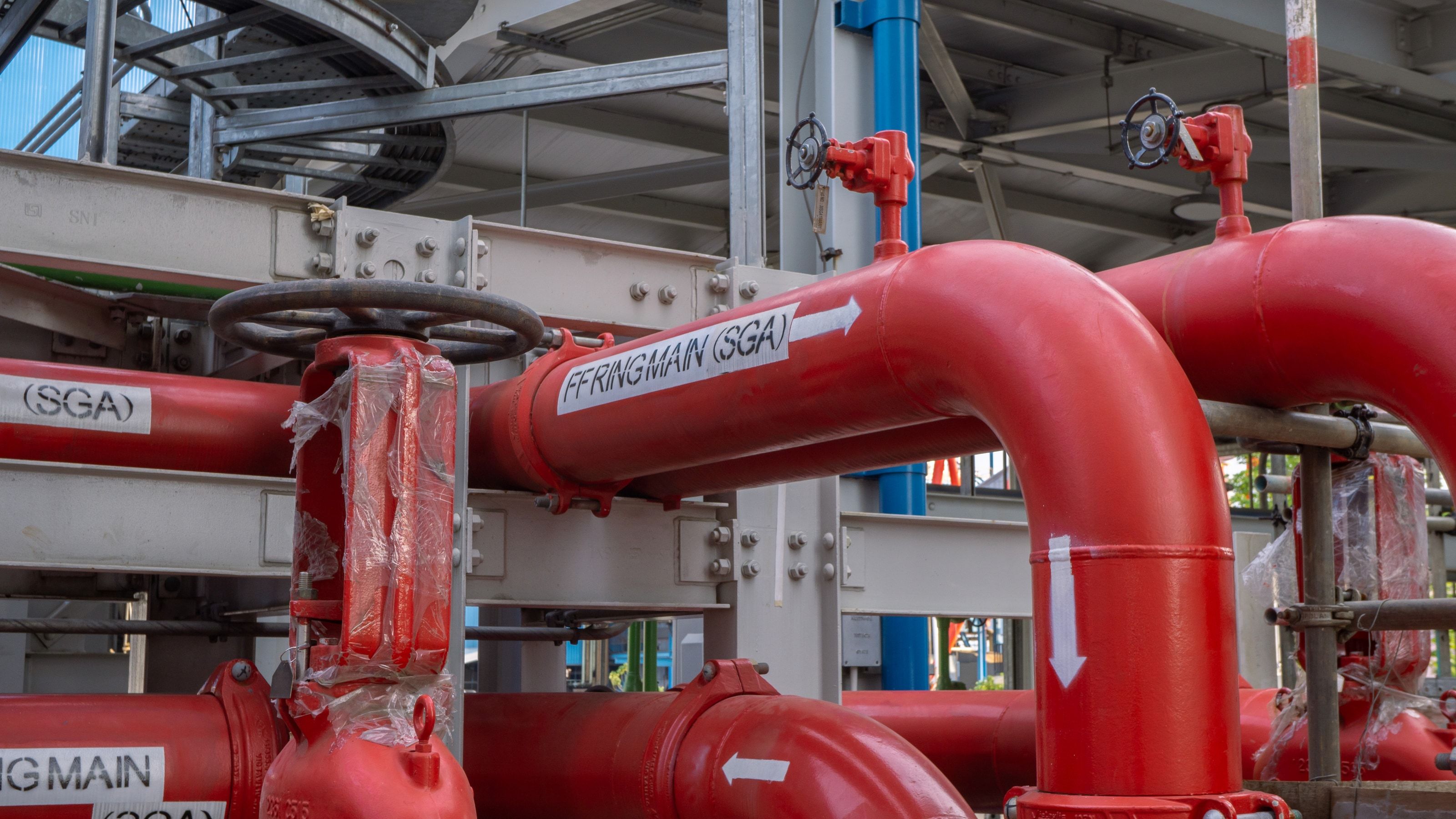 Linea de tuberias contra incendios y valvula manual en planta industrial